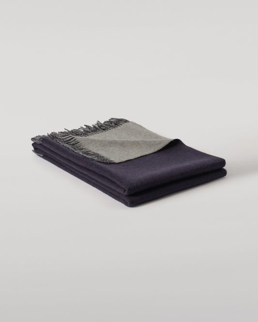 Johnstons of Elgin Interiors Collection  Reversible Navy & Light Grey Cashmere Throw on a wooden chair  WA000013RU6632N/A