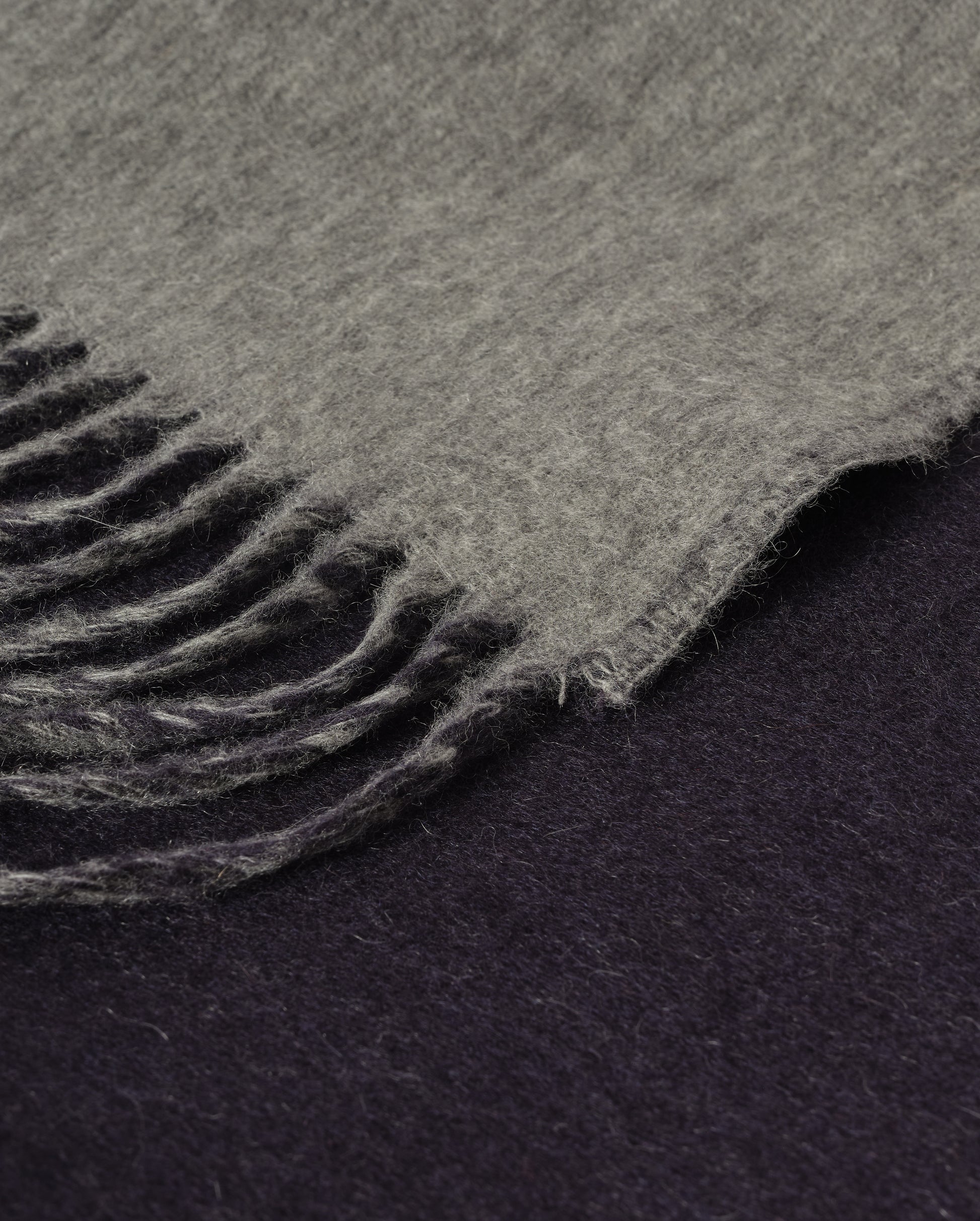 Johnstons of Elgin Interiors Collection  Reversible Navy & Light Grey Cashmere Throw on a wooden chair  WA000013RU6632N/A