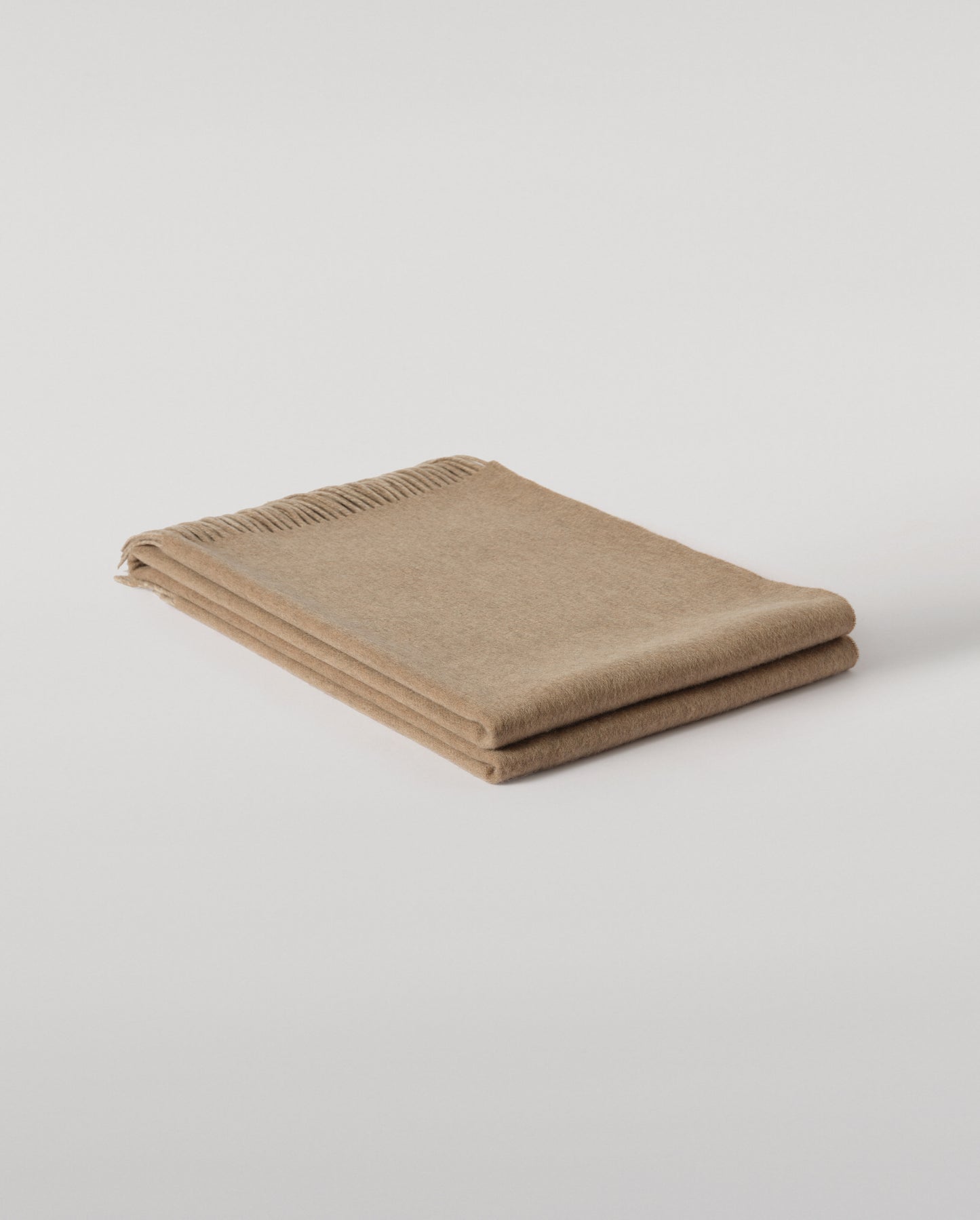 Johnstons of Elgin Interiors Collection Otter & Oatmeal Reversible Cashmere Throw on a grey background  WA000013RU7622ONE
