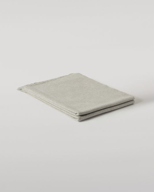 Johnstons of Elgin Interiors Collection  Silver Cashmere Throw on a wooden chair background  WA000055HA0100ONE