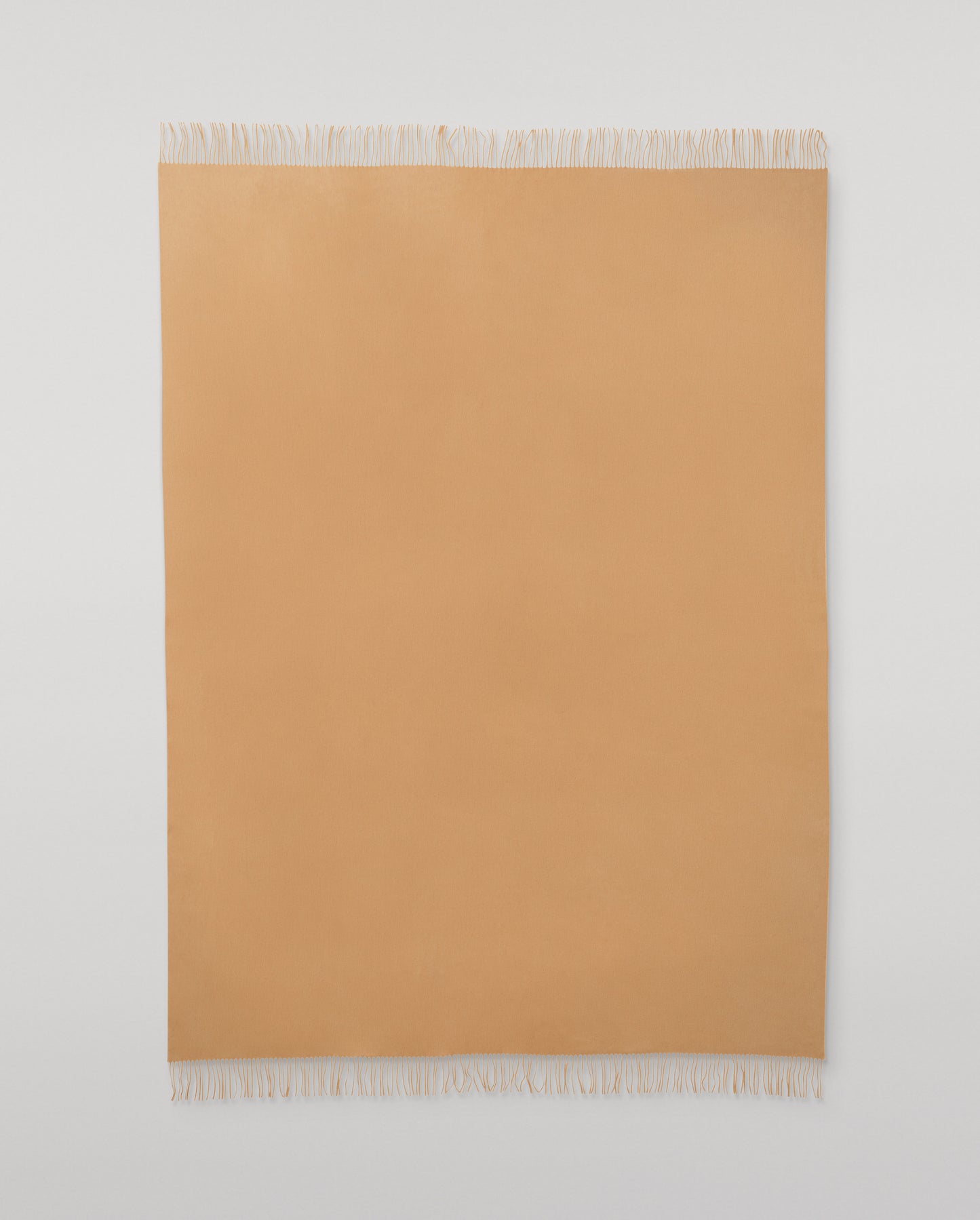 Johnstons of Elgin Interiors Collection Camel Camel Cashmere Throw on a wooden chair WA000055HB4315ONE