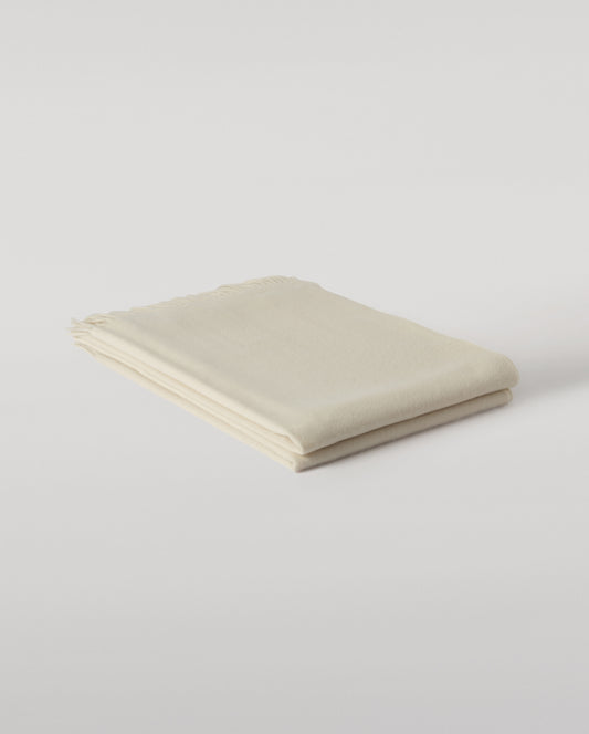 Johnstons of Elgin Interiors Collection White Cashmere Throw on grey background WA000055SA0000ONE
