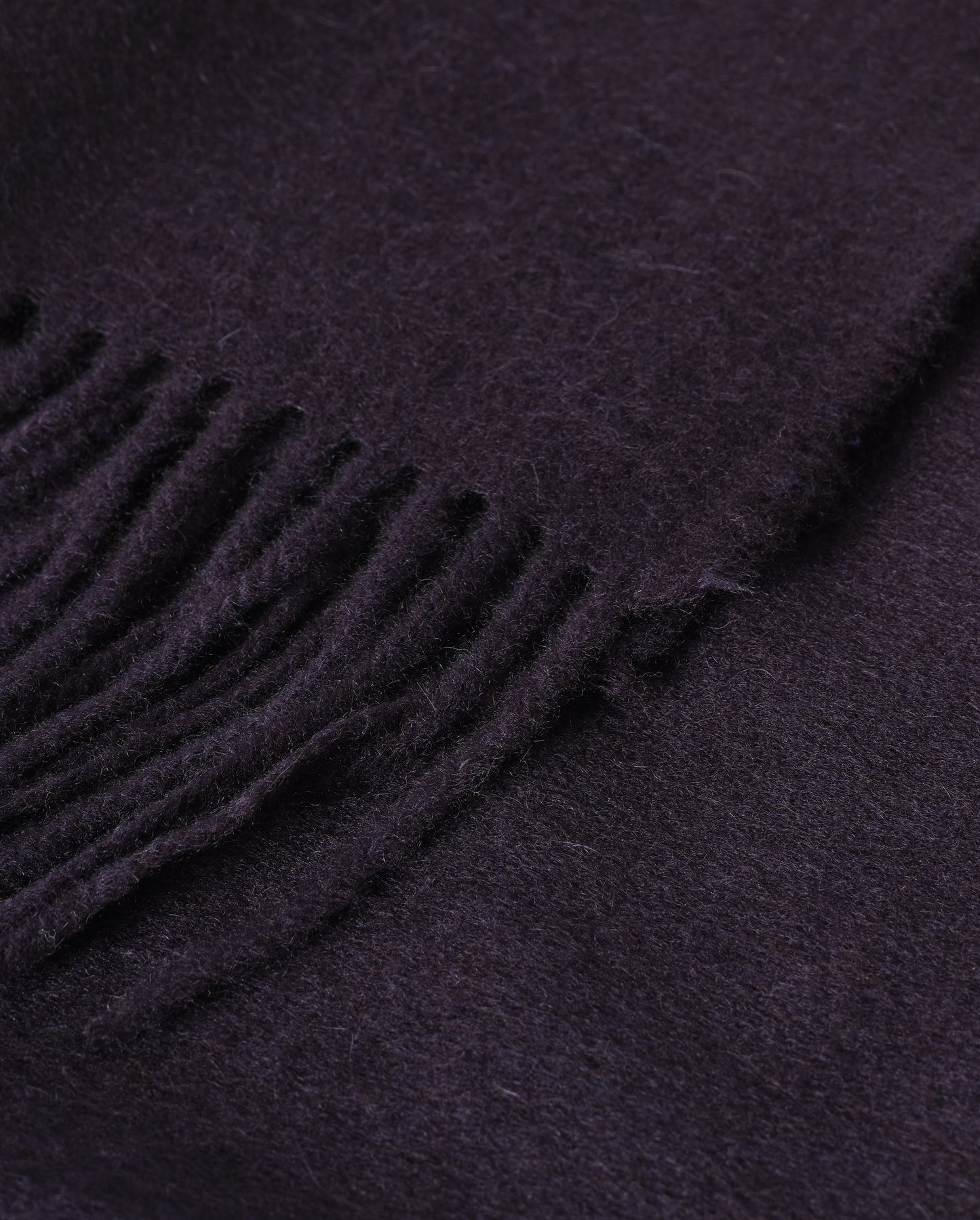 Johnstons of Elgin Interiors Collection  Dark Navy Cashmere Throw on a wooden chair   WA000055SD7330ONE