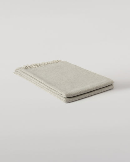 Johnstons of Elgin Interiors Collection Silver & White Reversible Cashmere Bed Throw on a white background  WA001374RU6322ONE