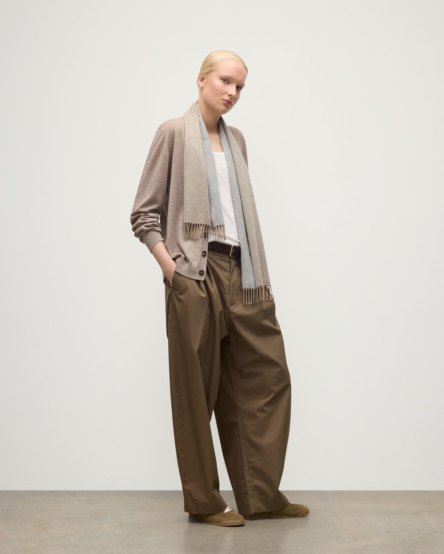 FEMALE MODEL WEARS JOHNSTONS OF ELGIN NATURAL BARD SCARF 100% CASHMERE OVER A LIOGHT BROWN CASHMERE CARDIGAN AND WHITE VEST WA002560RU7726ONE