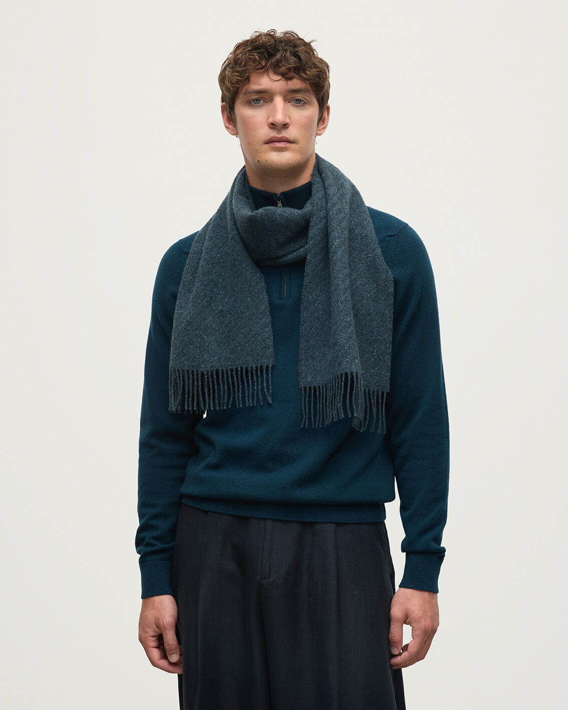 Model wears Johnstons of Elgin  Woven Accessories Storm Lofty Twill Blue Cashmere Scarf WAC02307RU7657ONE