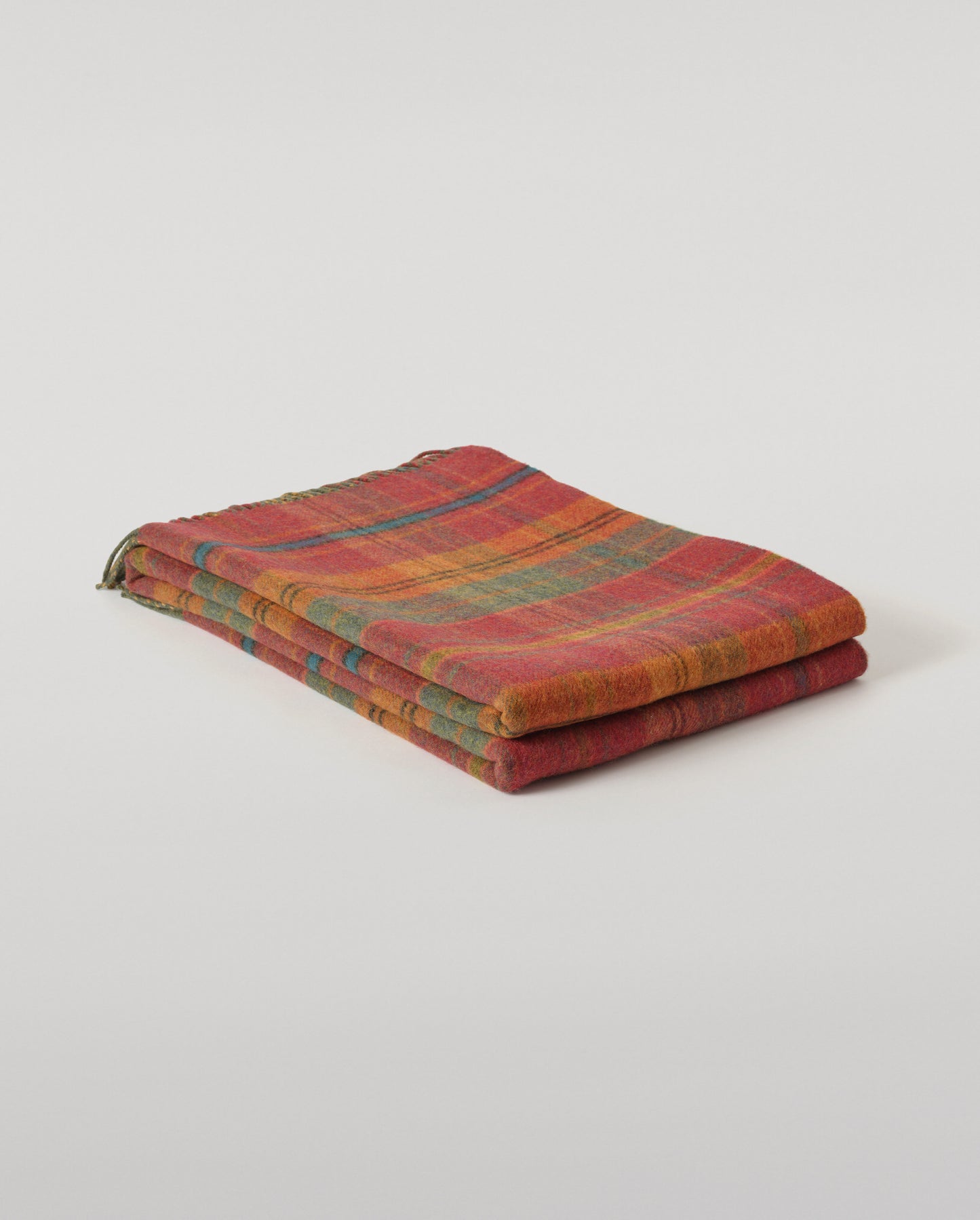 Johnstons of Elgin Interiors Collection Red Tweed & Green Windowpane Reversible Lambswool Throw on a grey background  WD000021XU0036N/A