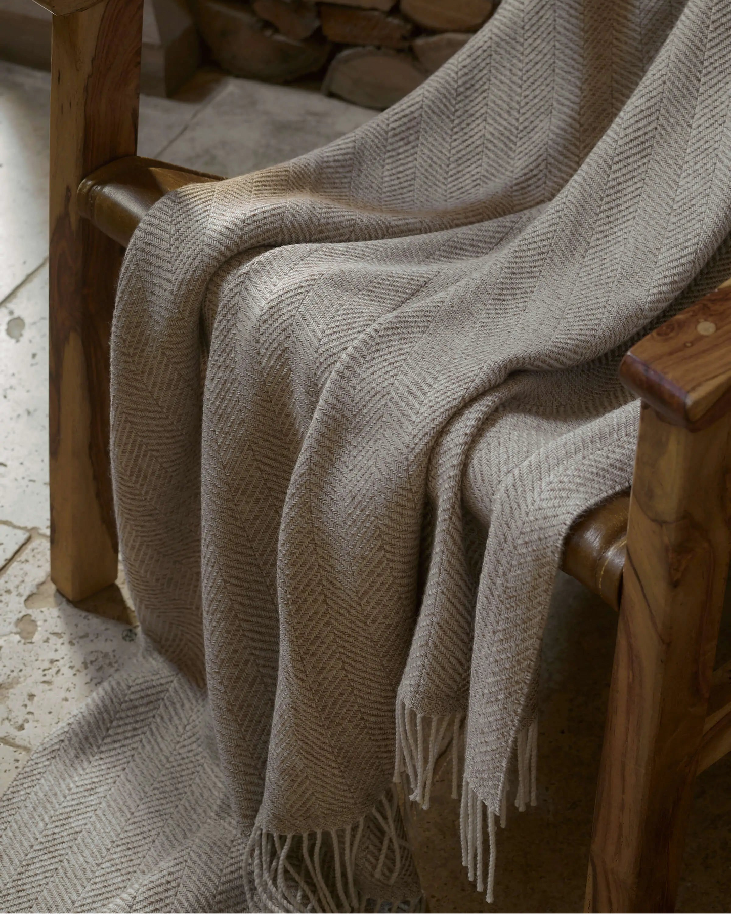 2025 Johnstons of Elgin Interiors Collection Natural Texture Herringbone Merino Throw on a wooden chair WD001221RU7455ONE